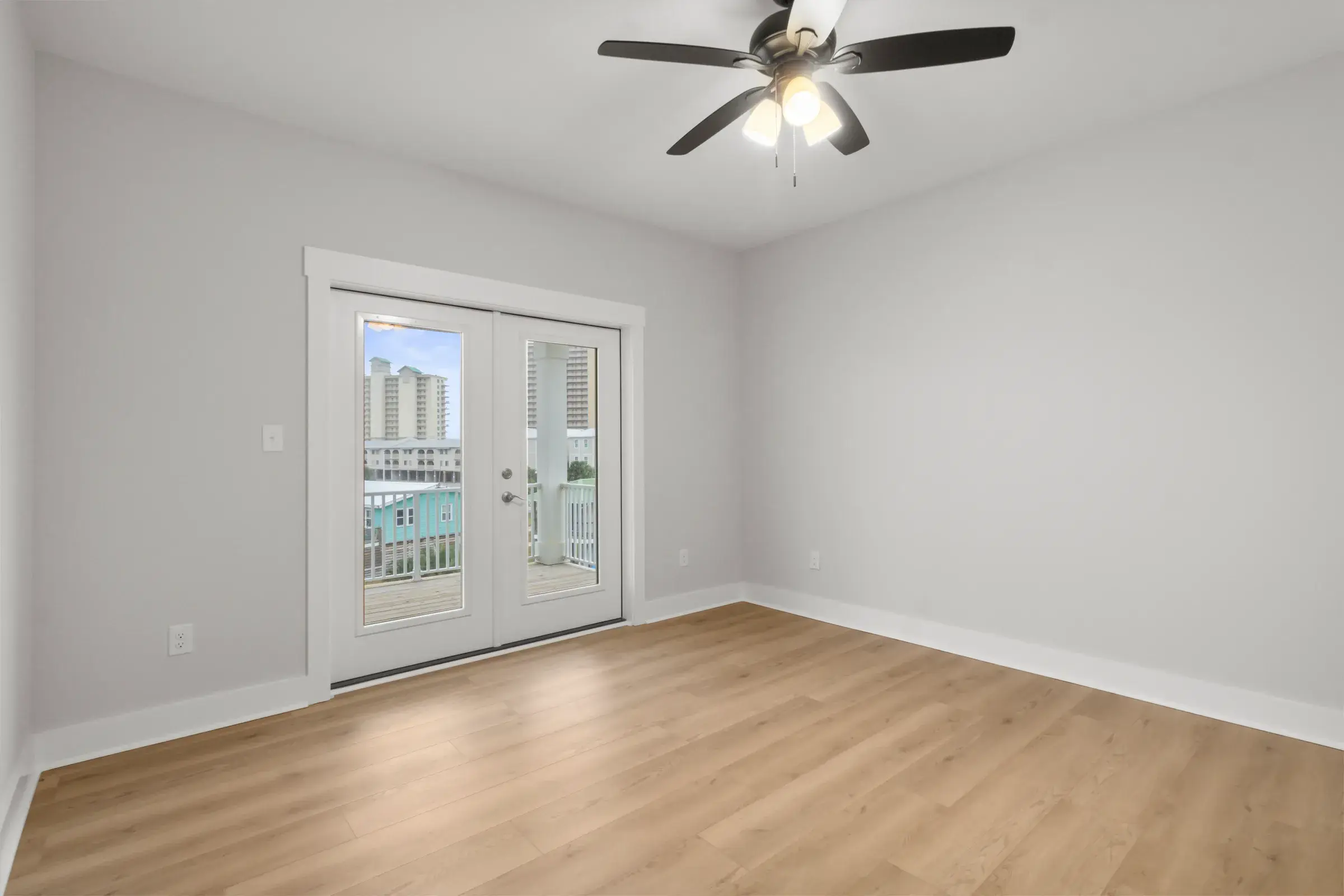 Bedroom with French doors opening to a balcony.